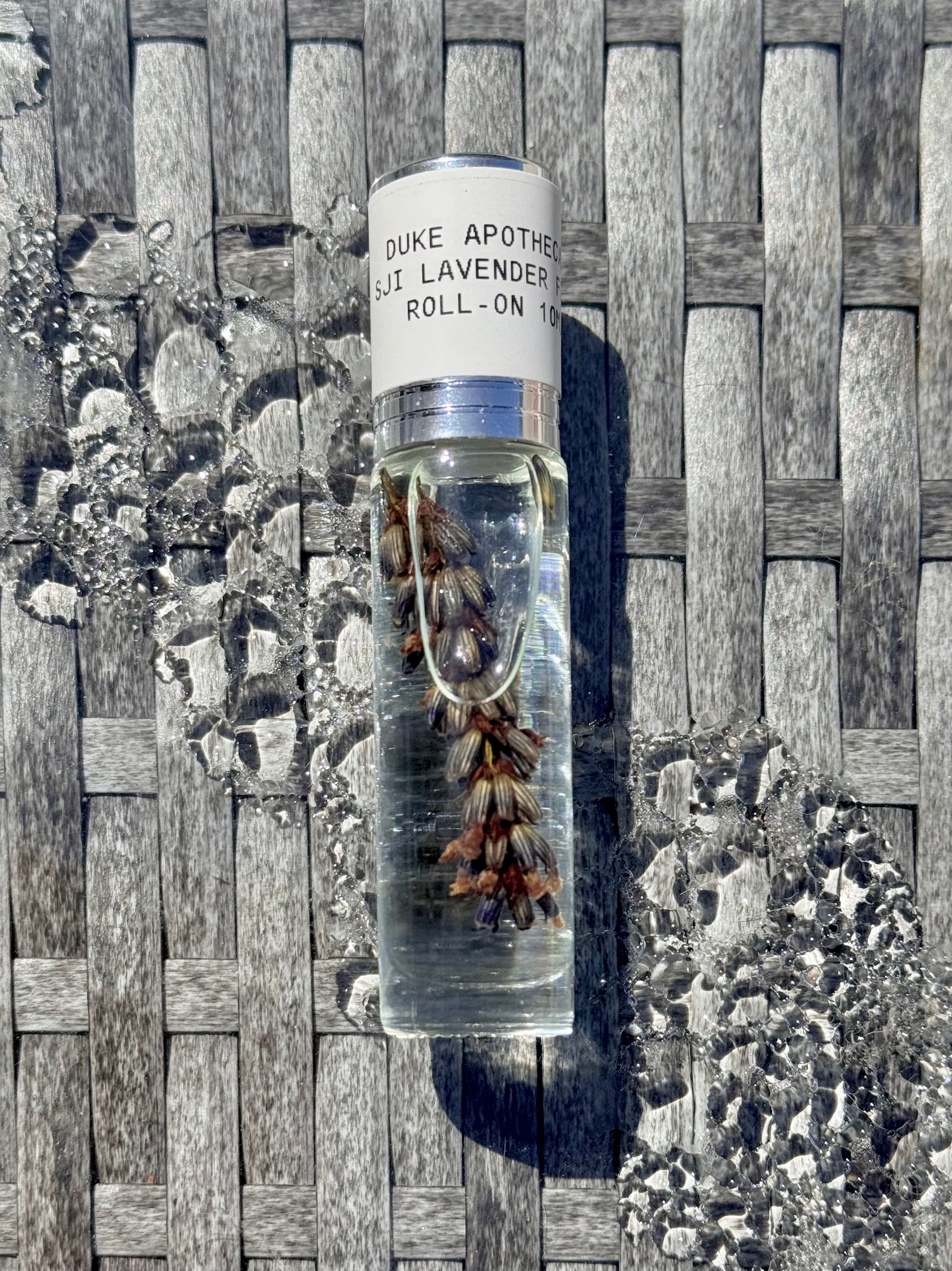 Duke Apothecary lavender roll-on bottle on a textured surface