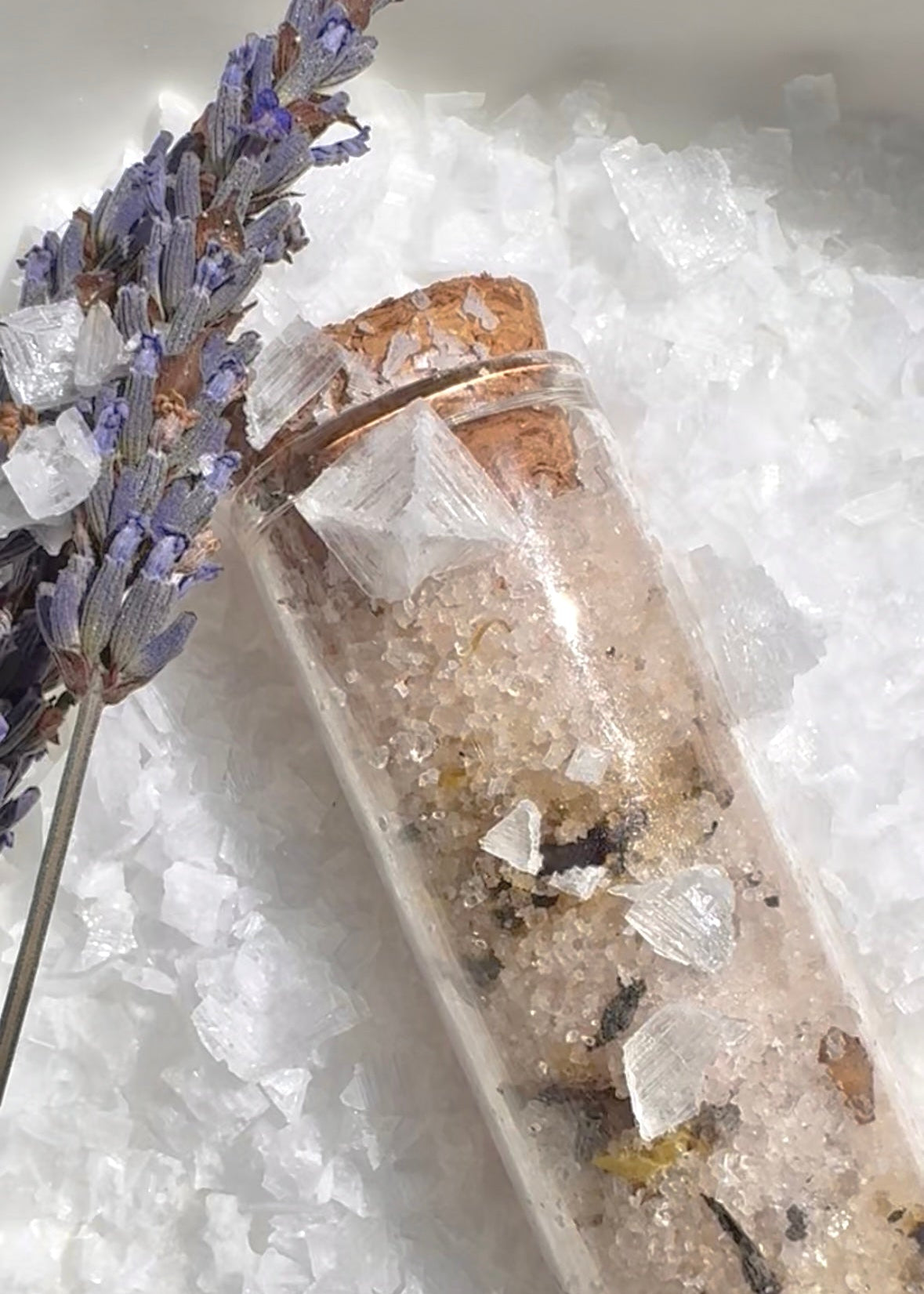Salt Crystals with lavender flowers on a white background