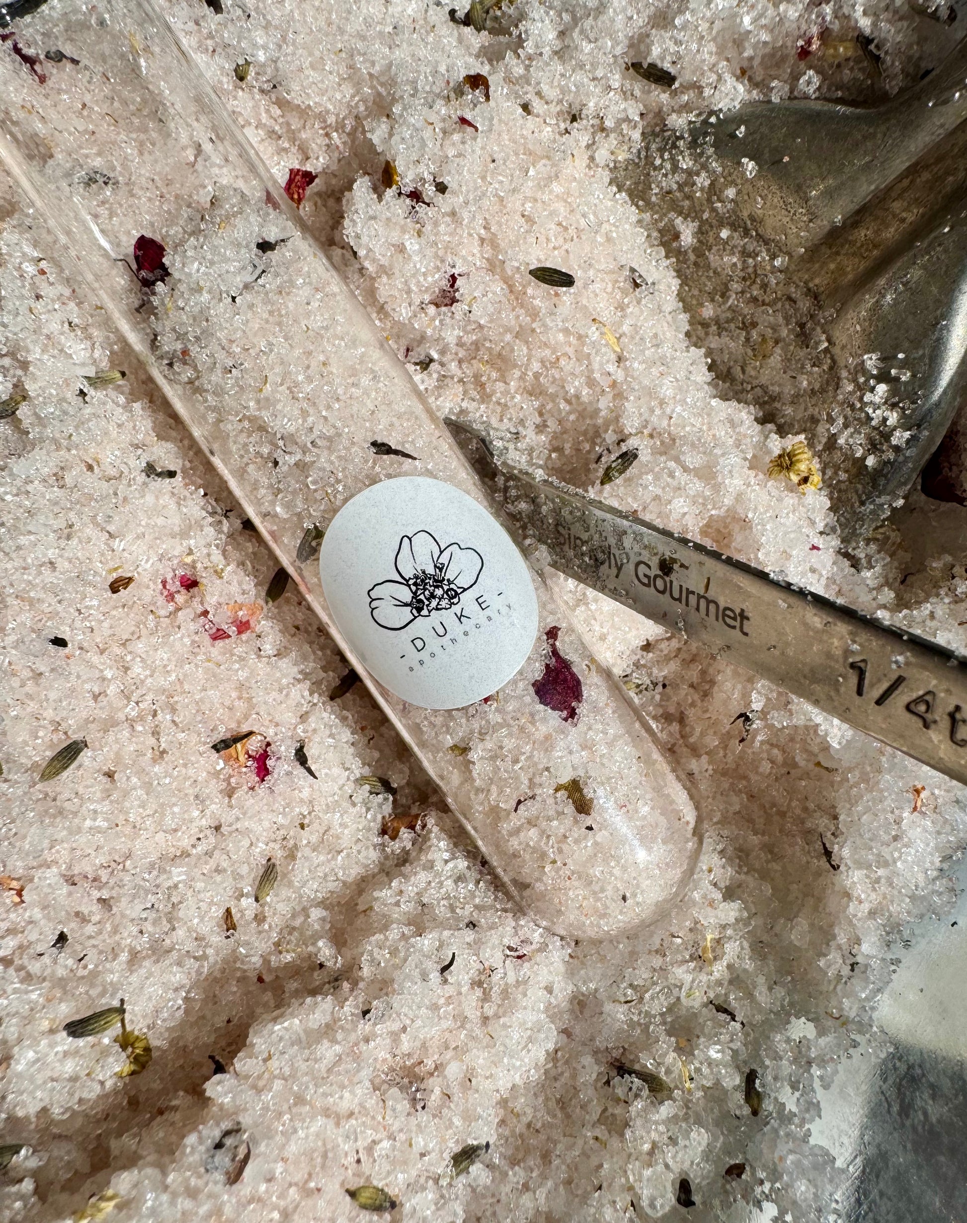 Duke Gourmet salt crystal with a branded label on a bed of salt crystals.