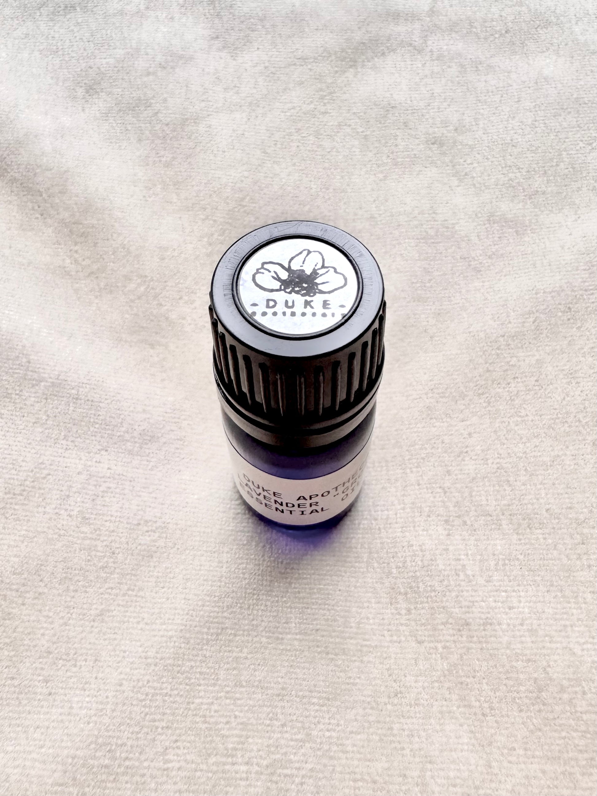 Small bottle with a Duke label on a textured surface