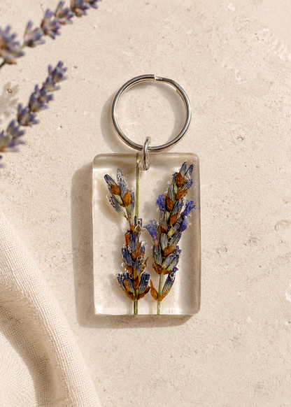 Keychain with pressed flowers on a beige background