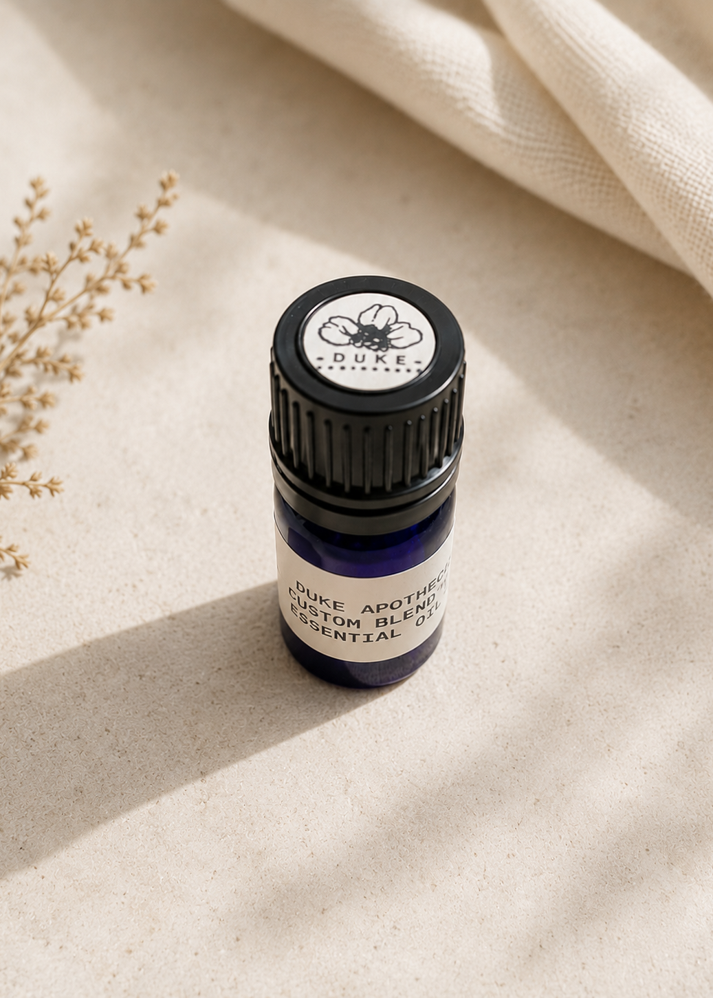 Essential oil bottle on a beige fabric background