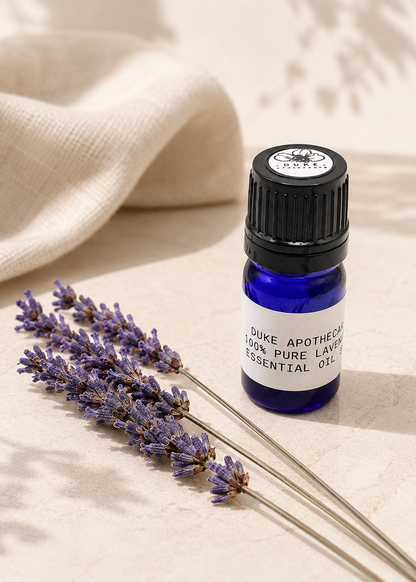 Essential oil bottle with lavender on a beige fabric background