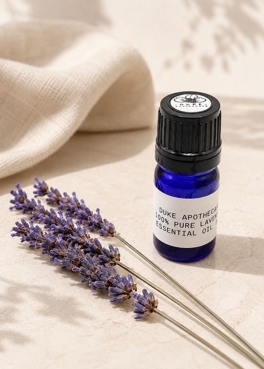 Essential oil bottle with lavender on a beige fabric background