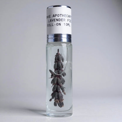 Roll-on bottle with lavender flowers on a gray background