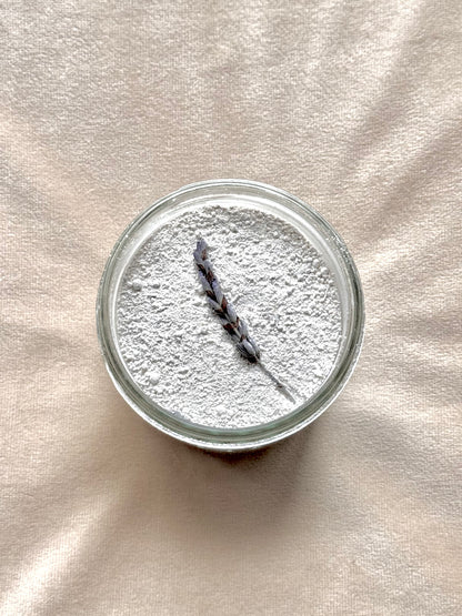 Glass jar with lavender on a beige fabric background